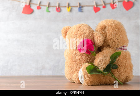 back side of two teddy Bear with red rose on marble background, concept valentine's and love Stock Photo