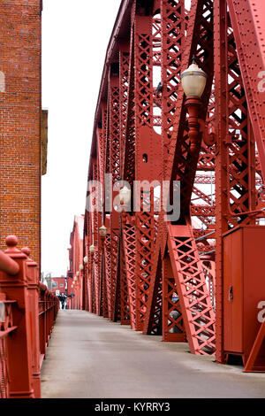 Spectacular red metal structures connected by rivets Broadway bridge with lanterns through the Willamette River in Portland Down Town Stock Photo