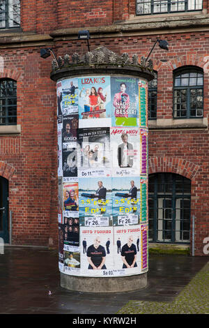 Europe, Germany, Cologne, advertising pillar with event notes in front of the Stollwerck house, historical building of the former chocolate factory St Stock Photo