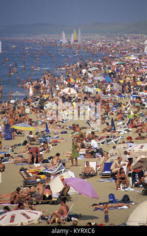 The Netherlands, Scheveningen, near The Hague or in Dutch: Den Haag. People sunbathing on the beach. Summertime. Aerial view from pier. Stock Photo