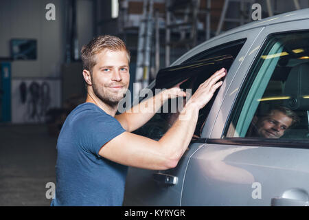 Male hand with spray, car window tint installation process, installing  procedure, tinting film Stock Photo - Alamy