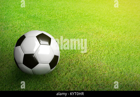 3D Rendered black and white soccer ball on green soccer football field background with copy space and grain processed Stock Photo