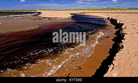 Sandy beach eroded by the outgoing tide at Dugort, Achill Island on the Irish coast Stock Photo