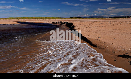 Sandy beach eroded by the outgoing tide at Dugort, Achill Island on the Irish coast Stock Photo