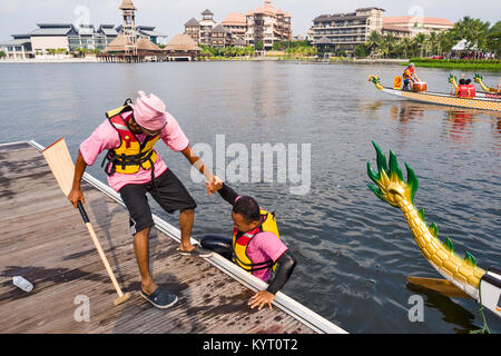 PUTRAJAYA, KUALA LUMPUR, MALAYSIA - june 18, 2010 : before the departure some rowers throw themselves into the water during the dragon boat festival o Stock Photo