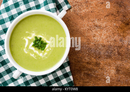 zucchini soup in bowl on brown background. Top view Stock Photo
