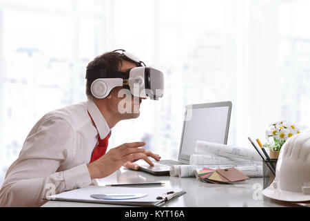 Designer watching interestedly 3d content in virtual reality glasses in the office. Horizontal composition. Stock Photo