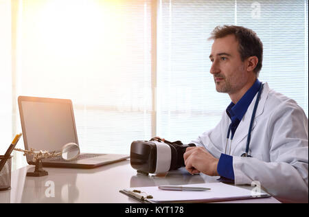 Doctor in his workplace working with virtual reality glasses applied to the medical study. Horizontal composition. Stock Photo