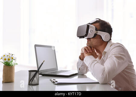 Office worker watching audiovisual content 3d with virtual reality glasses in the office. Horizontal composition. Stock Photo