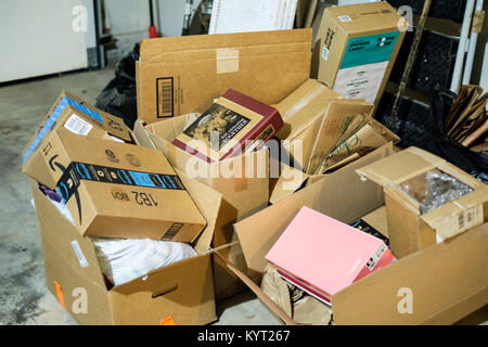 A pile of cardboard boxes in a garage saved for moving day. Oklahoma, USA. Concepts. Stock Photo