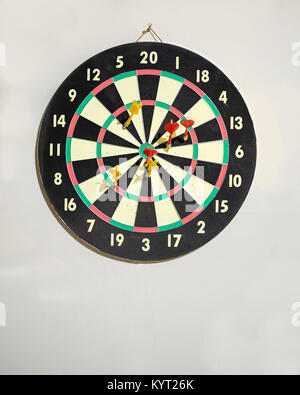 A game dartboard and darts hanging on the wall inside of a garage in Oklahoma, USA. Stock Photo