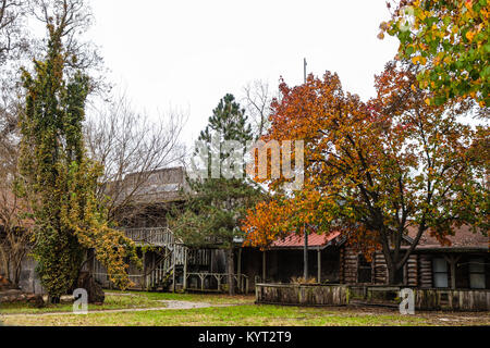 Abandonded old frontier city replica with log buildings in the autumn Stock Photo