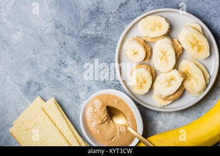 Light Healthy Snack made from Banana Slices, Cashew Butter and Gluten Free Crispbreads Stock Photo