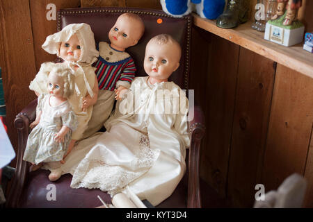 Group of old dolls on display in a antique shop. Stock Photo