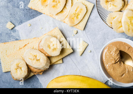 Light Healthy Snack made from Banana Slices, Cashew Butter and Gluten Free Crispbreads Stock Photo