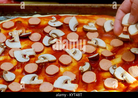 make pizza, pizza cooking Cook in the kitchen putting the ingredients on the pizza Stock Photo