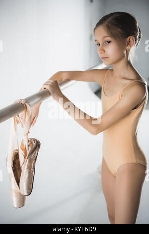 The girl is training near the ballet barre. Stock Photo