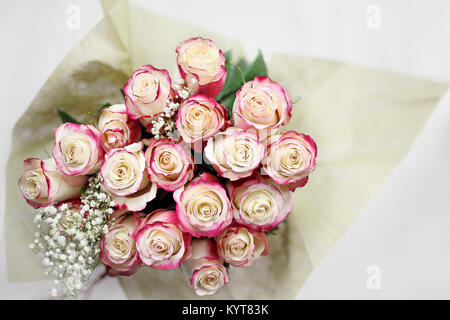 Beautiful bouquet of  red and white roses with baby's breath shot from above. Selective focus on tips of roses with extreme shallow depth of field. Stock Photo