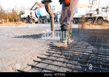 Concrete pouring during commercial concreting floors of buildings in construction - concrete slab Stock Photo