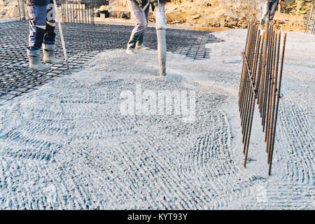 Concrete pouring during commercial concreting floors of buildings in construction site - concrete slab Stock Photo