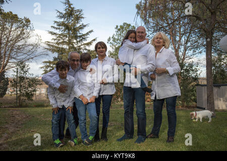 Family of many members, celebrating a party in the garden of their home Stock Photo