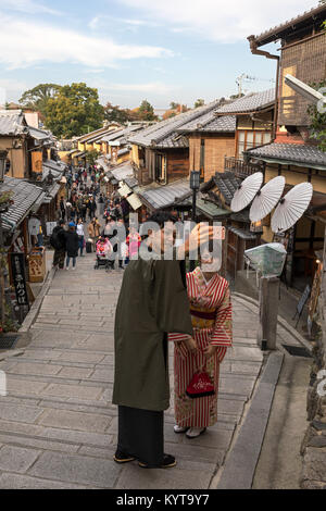 Kyoto, Japan, Nov. 7, 2017: A couple dressed in traditional Japanese clothes take a selfie in Ishibei-koji street in eastern Kyoto. Stock Photo