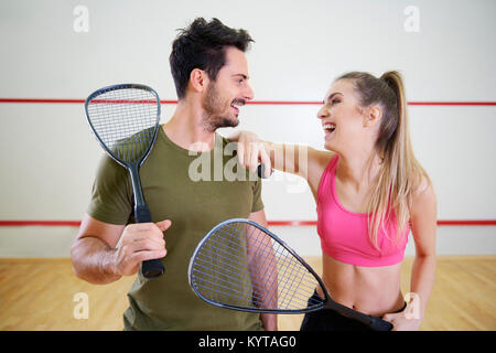 Squash couple flirting on court Stock Photo