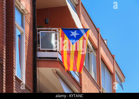 BARCELONA, SPAIN -  June 20, 2017 : example of a building facade in a residential area of the city where floats a Catalan flag on a summer day Stock Photo