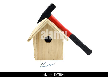 building bird nesting box with hammer, nails. white isolated background Stock Photo