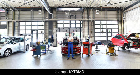 portrait of a successful mechanic in a garage - repair and service of vehicles Stock Photo