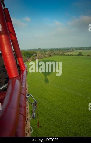 Shadows of a hot air balloon in the Kent landscape taken from the basket early in the morning Stock Photo