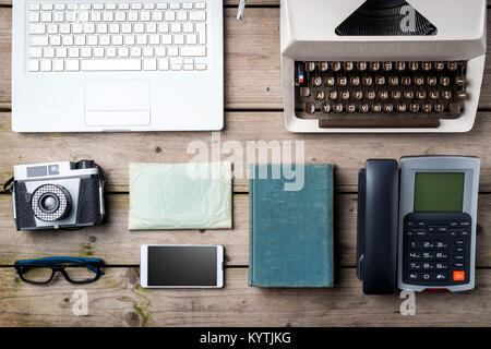 Technology progress, old and modern digital devices on wooden table Stock Photo