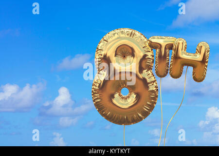 Gold number 8 foil birthday balloon against a bright blue summer sky. Golden party celebration. 3D Rendering Stock Photo