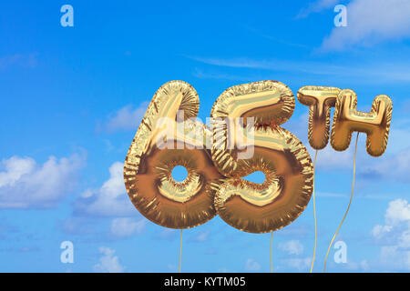 Gold number 65 foil birthday balloon against a bright blue summer sky. Golden party celebration. 3D Rendering Stock Photo