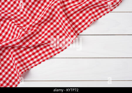 Red checkered tablecloth over white wooden table Stock Photo