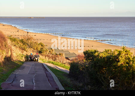 Retired couple reading at Frinton on Sea Stock Photo
