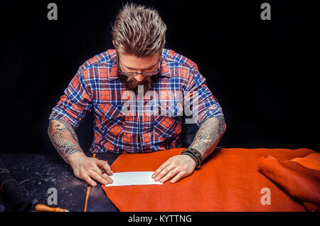 Man working with leather manufacturing new leather product Stock Photo