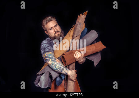 Craftsman working with leather forms new leather product Stock Photo