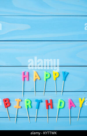 Birthday candles on blue wooden table Stock Photo