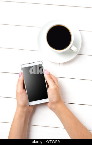 Woman using modern smart phone over white wooden table Stock Photo