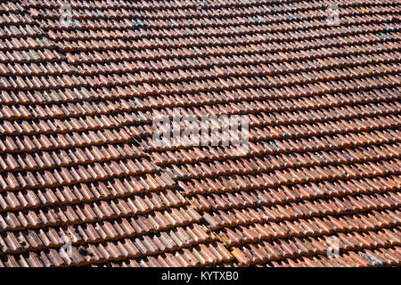 A large expanse of rustic French roof tiles, full frame construction background texture Stock Photo