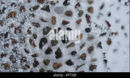 Old cobblestones covered with snow in winter, in Lodz Poland Stock Photo