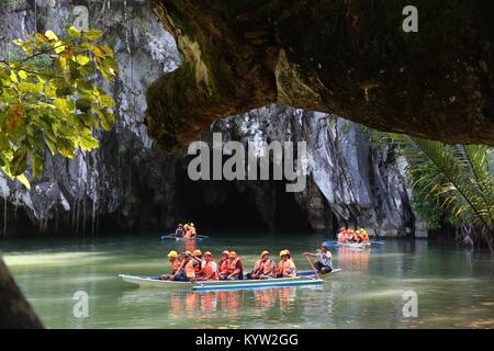 PUERTO PRINCESA, PHILIPPINES - NOVEMBER 29, 2017: People ride the boats to underground river in Puerto Princesa, Philippines. Puerto Princesa Subterra Stock Photo