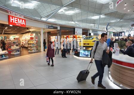 LONDON, UK - APRIL 24, 2016: People visit duty free shops in London Stansted Airport, UK. With 22.5 million passengers in 2015 Stansted was the 4th bu Stock Photo