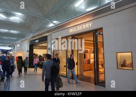 LONDON, UK - APRIL 24, 2016: People visit duty free shops in London Stansted Airport, UK. With 22.5 million passengers in 2015 Stansted was the 4th bu Stock Photo