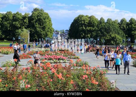 OSLO, NORWAY - AUGUST 2, 2015: People visit gardens and Vigeland Installation in Frogner Park, Oslo. 212 sculptures around the park were all designed  Stock Photo