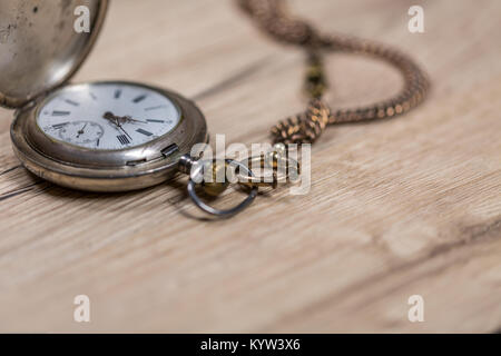 Vintage pocket-watch on the rustic desk Stock Photo