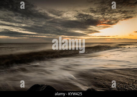 Stormy winter sea and sunset, Felpham, Bognor Regis, West Sussex, UK Stock Photo