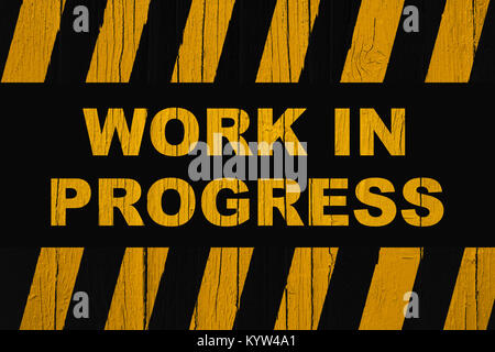 Work in progress warning sign with yellow and black stripes painted ...