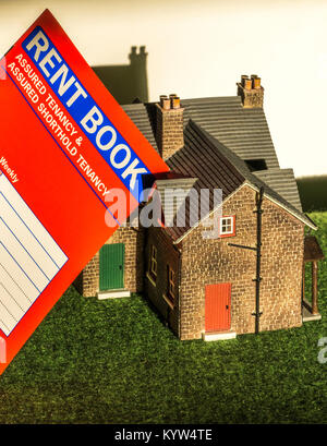 A model house and rent book, used for a private sector, assured shorthold tenancy, in England and Wales. General concept of renting / letting a home. Stock Photo